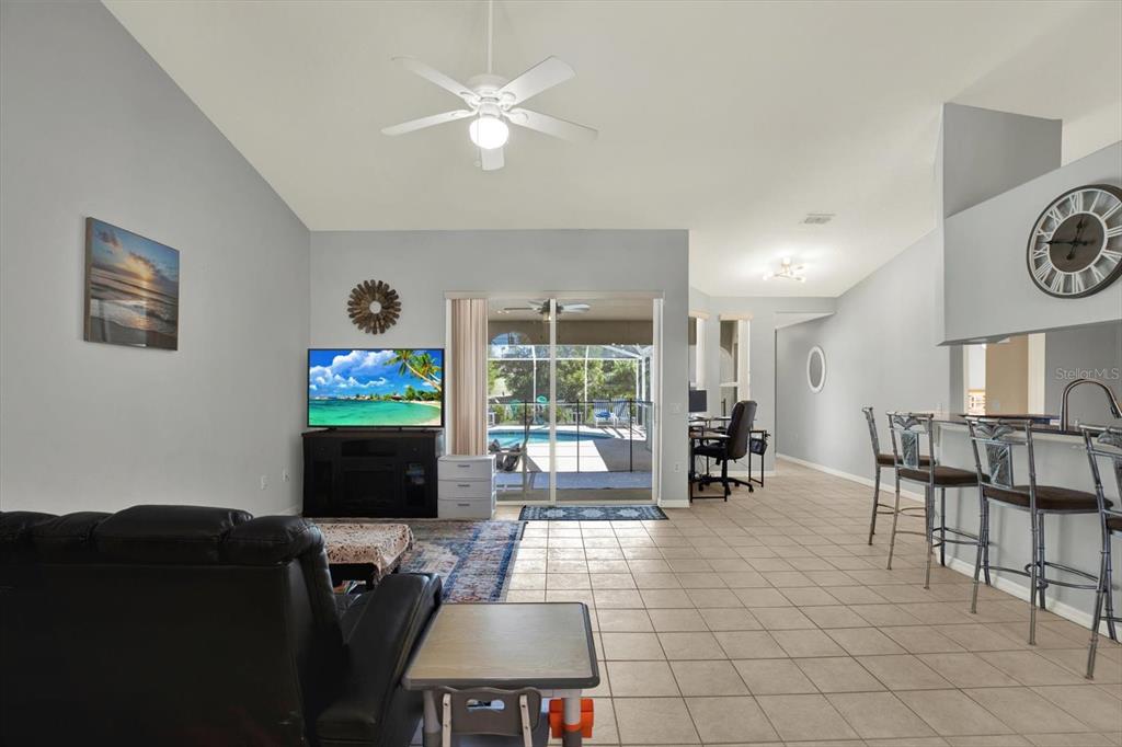 5220 Kirkwood Avenue Spring Hill, FL 34608 - Photo 10 of 39 a living room with furniture a flat screen tv and a fireplace