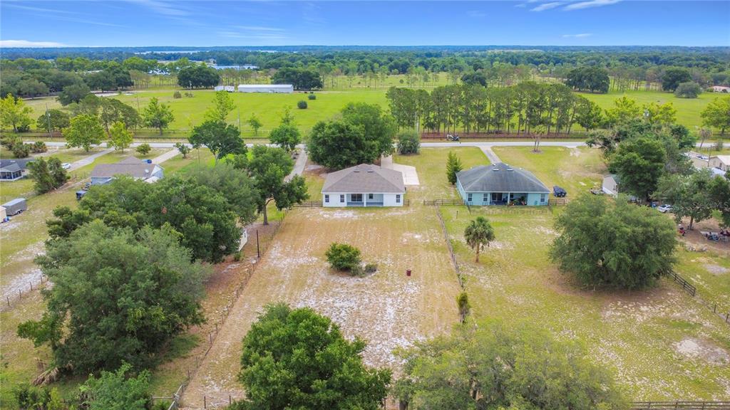 28549 Shirley Shores Road Tavares, FL 32778 - Photo 65 of 65 an aerial view of residential houses with outdoor space and swimming pool