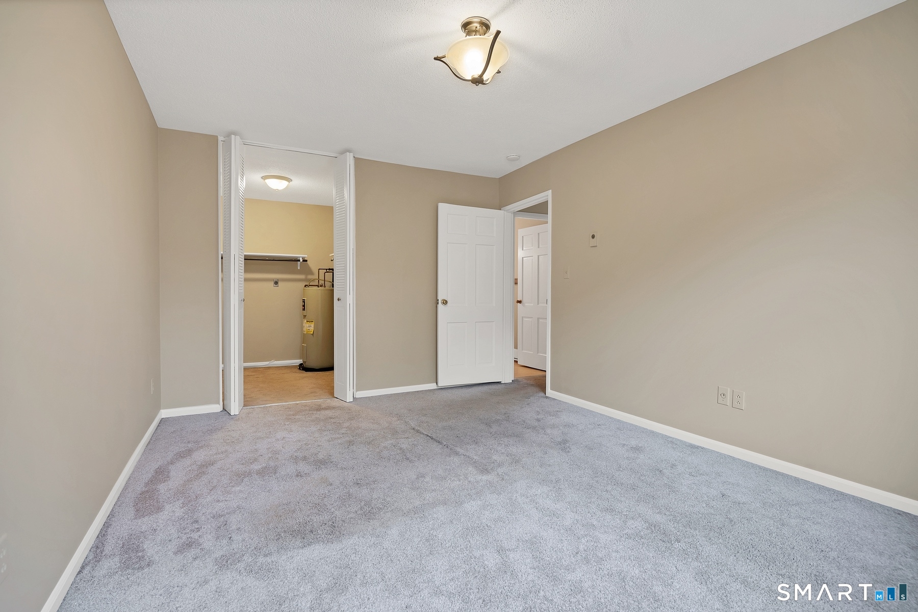111 Niles Hill Road, Unit E New London, CT 06320 - Photo 22 of 26 a view of an empty room with a chandelier fan
