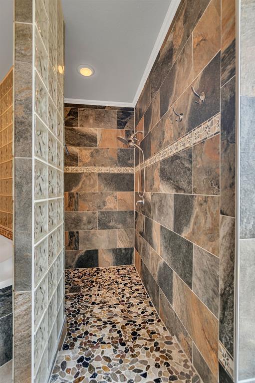 50 Buckingham Lane Allen, TX 75002 - Photo 29 of 39 Bathroom featuring a tile shower, stone finish floors, and recessed lighting