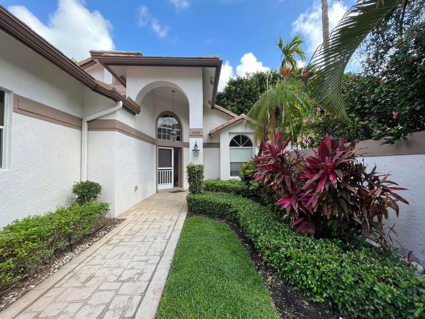 5348 Northwest 20th Avenue Boca Raton, FL 33496 - Photo 1 of 1 a front view of a house with a yard