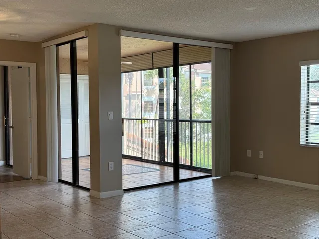 a view of a hallway to a livingroom with furniture and a chandelier