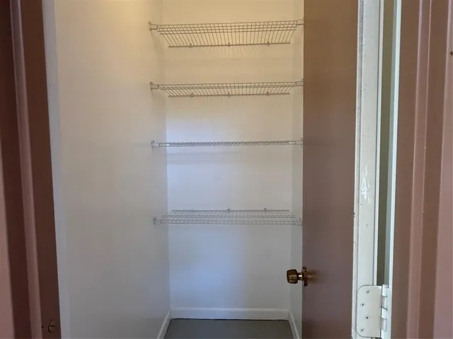 a view of a house with a window and wooden fence