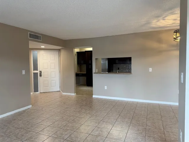 a kitchen with granite countertop a refrigerator and a sink