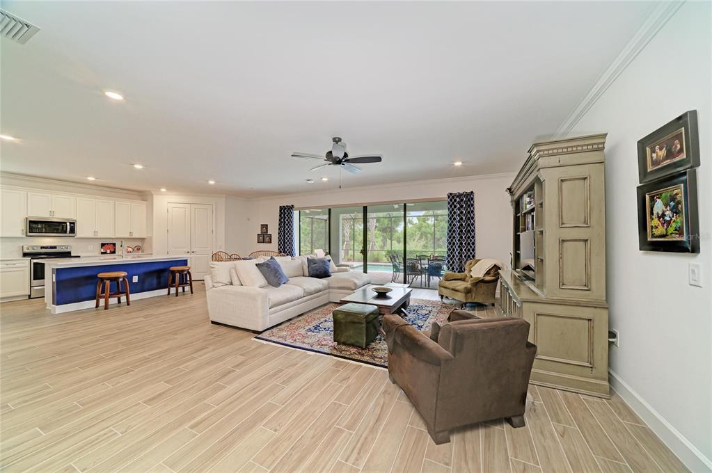 16341 Hidden Oak Loop Lakewood Ranch, FL 34211 - Photo 10 of 76 a living room with furniture and a large window
