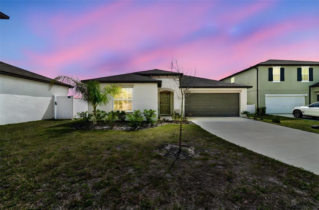 a front view of a house with a yard and garage