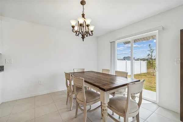 a bedroom with bed and a chandelier
