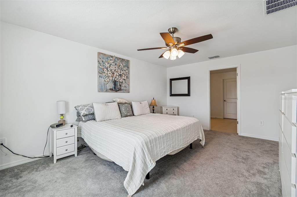 4530 Cozy Condor Court Bartow, FL 33830 - Photo 12 of 35 a bedroom with bed and a chandelier