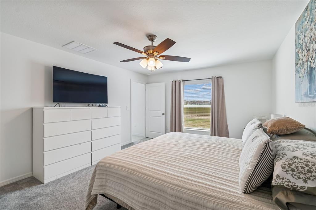 4530 Cozy Condor Court Bartow, FL 33830 - Photo 13 of 35 a bedroom with a bed and a flat screen tv