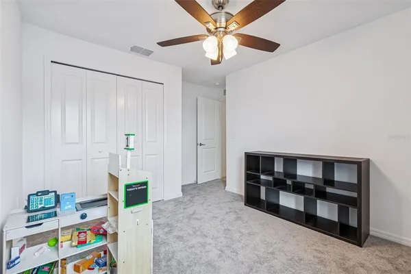 a bathroom with a granite countertop sink a toilet a mirror and bathtub