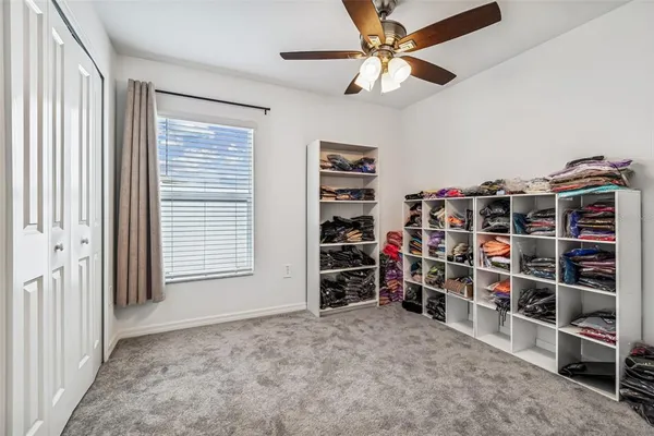 a bathroom with a granite countertop sink and a toilet