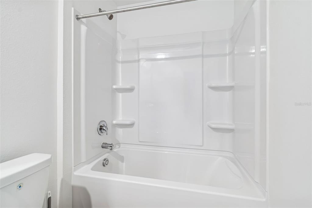 4530 Cozy Condor Court Bartow, FL 33830 - Photo 23 of 35 a white bath tub sitting next to a white toilet and vanity