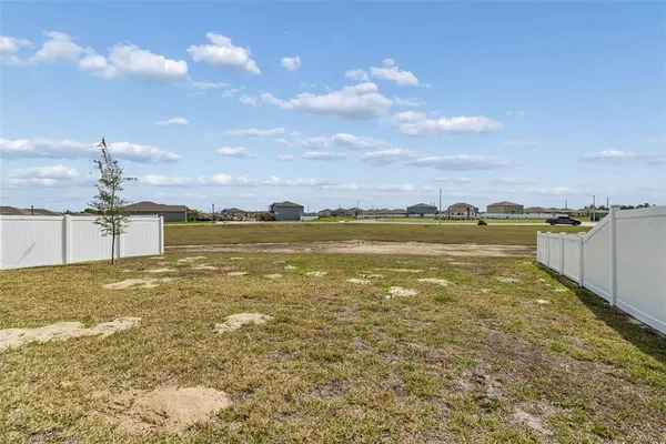 an aerial view of residential houses with outdoor space and parking