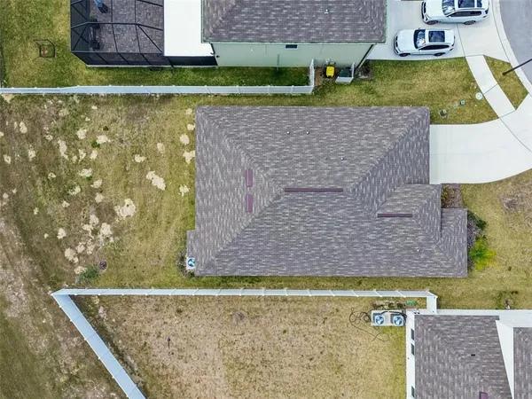 an aerial view of residential houses with outdoor space and swimming pool