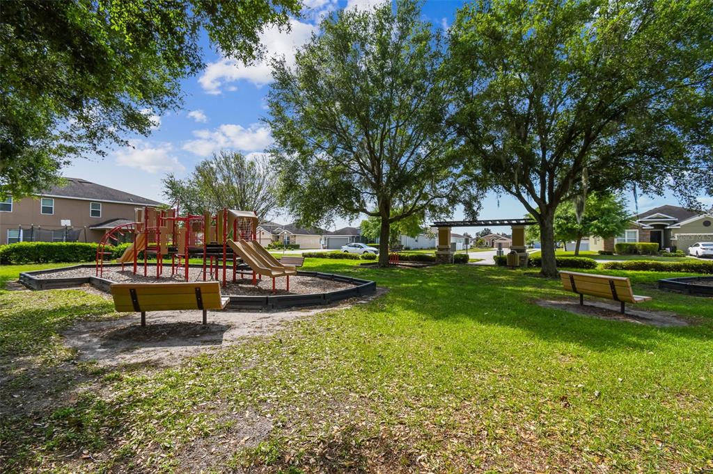 4530 Cozy Condor Court Bartow, FL 33830 - Photo 30 of 35 a park view with a bench in a garden