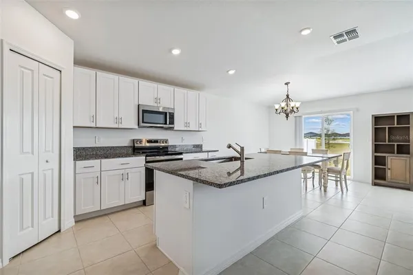 a kitchen with granite countertop a sink and appliances