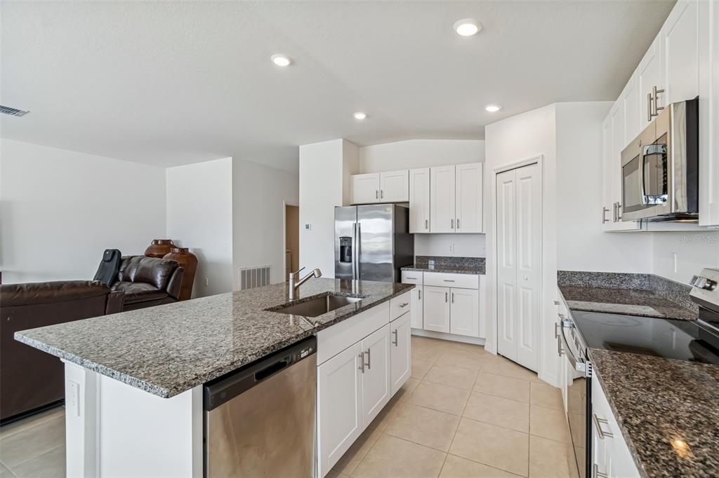 4530 Cozy Condor Court Bartow, FL 33830 - Photo 5 of 35 a kitchen with stainless steel appliances granite countertop a sink dishwasher stove refrigerator and cabinets