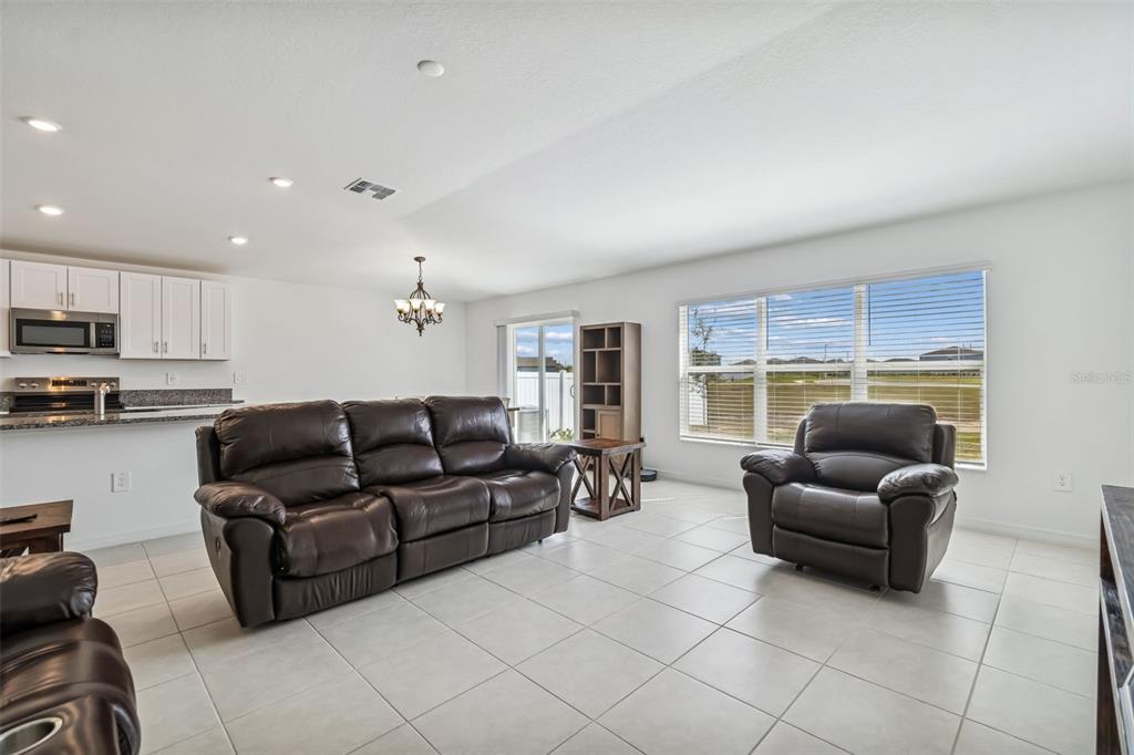 4530 Cozy Condor Court Bartow, FL 33830 - Photo 6 of 35 a living room with furniture and a large window