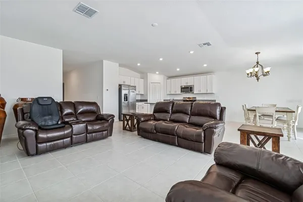 a living room with furniture and a chandelier