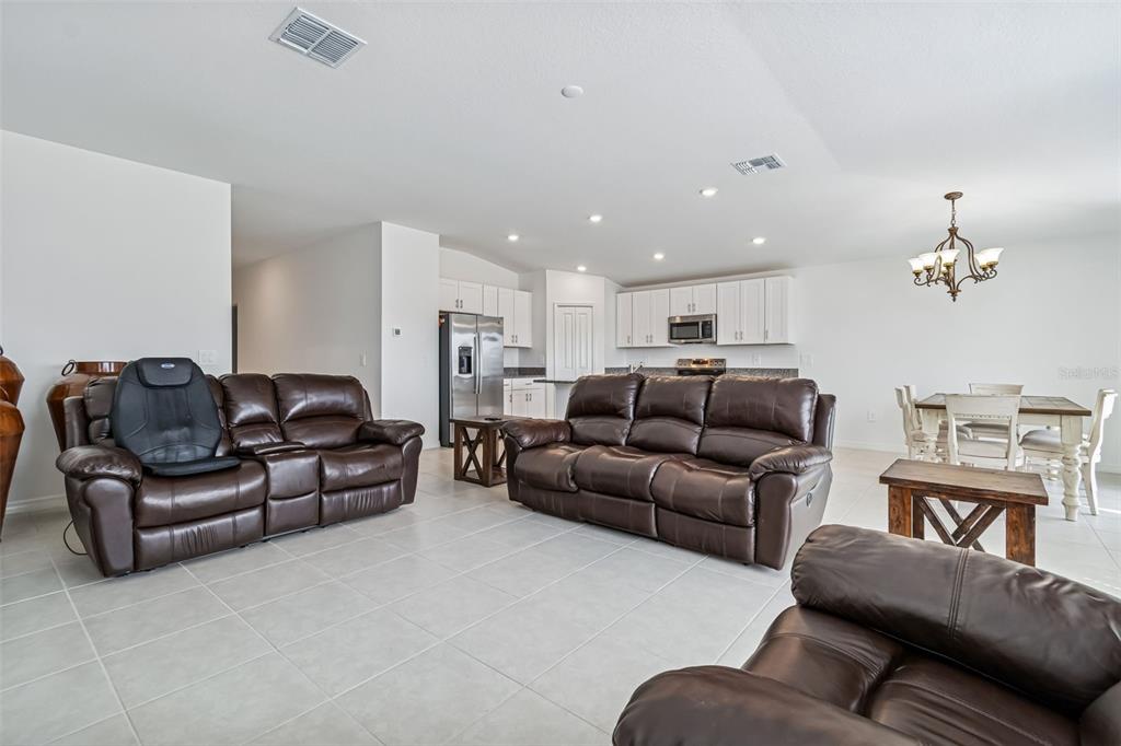 4530 Cozy Condor Court Bartow, FL 33830 - Photo 8 of 35 a living room with furniture and a chandelier