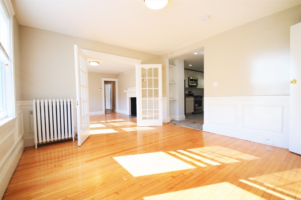 51 Leamington Road, Unit 1 Boston, MA 02135 - Photo 4 of 12 a view of a room with wooden floor and a window