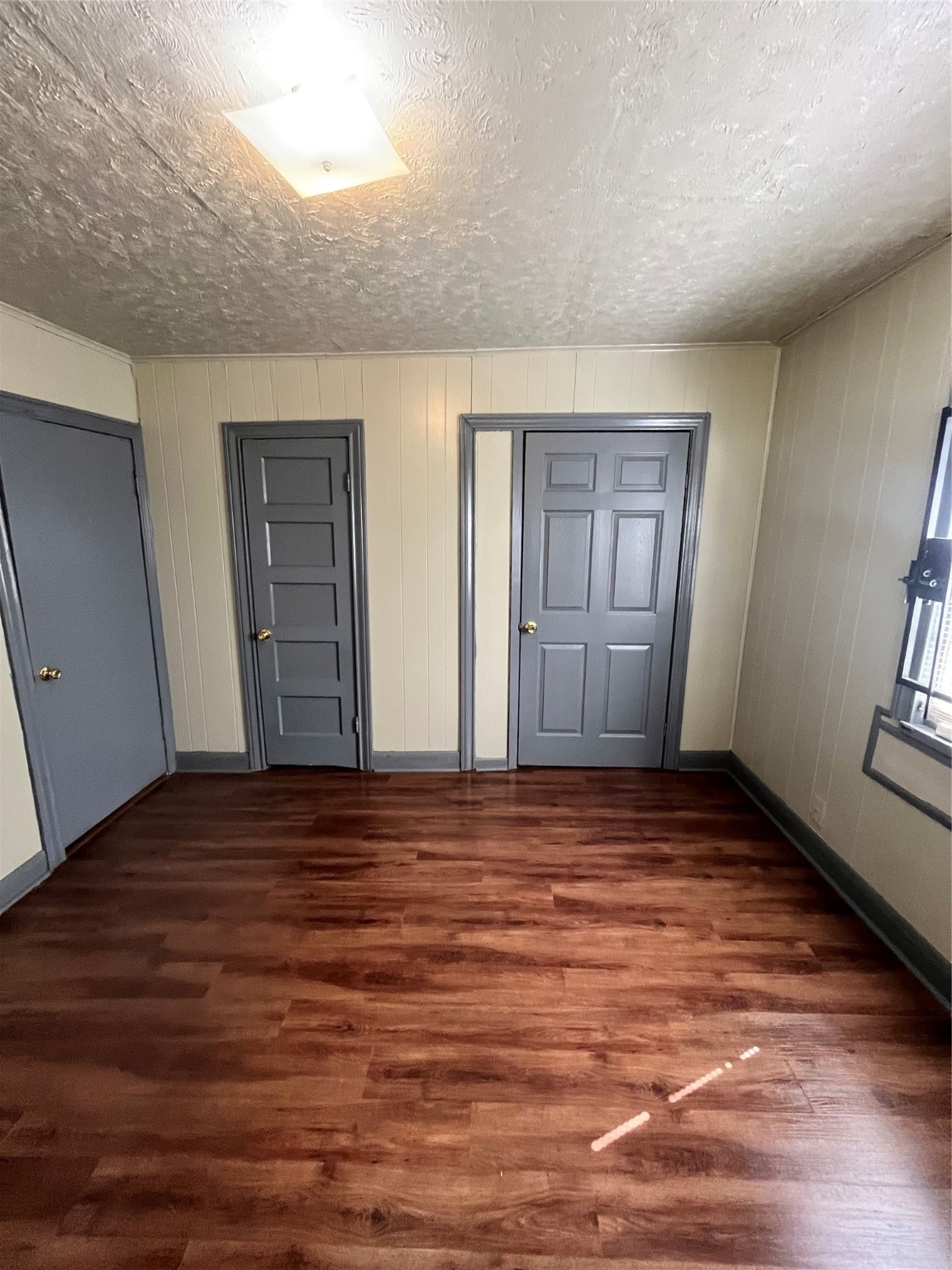 4609 Dabney Street Houston, TX 77026 - Photo 15 of 19 a view of an empty room with window and wooden floor