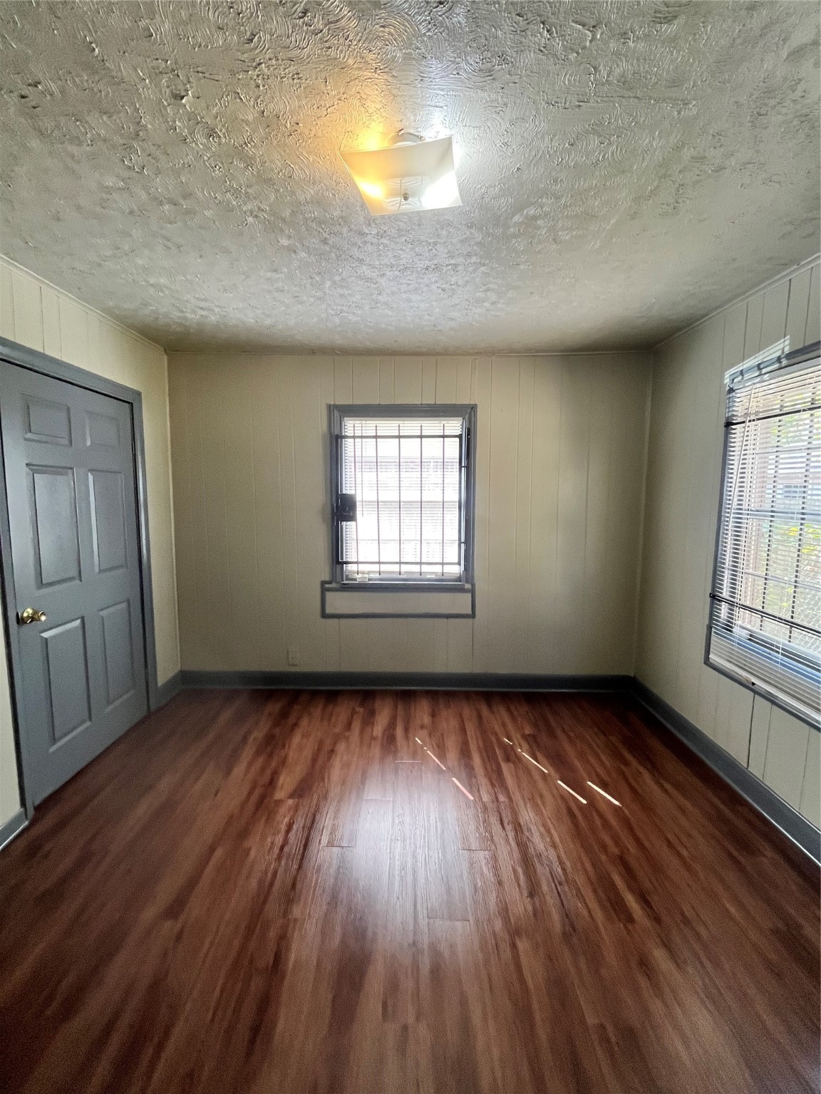 4609 Dabney Street Houston, TX 77026 - Photo 16 of 19 an empty room with wooden floor and windows