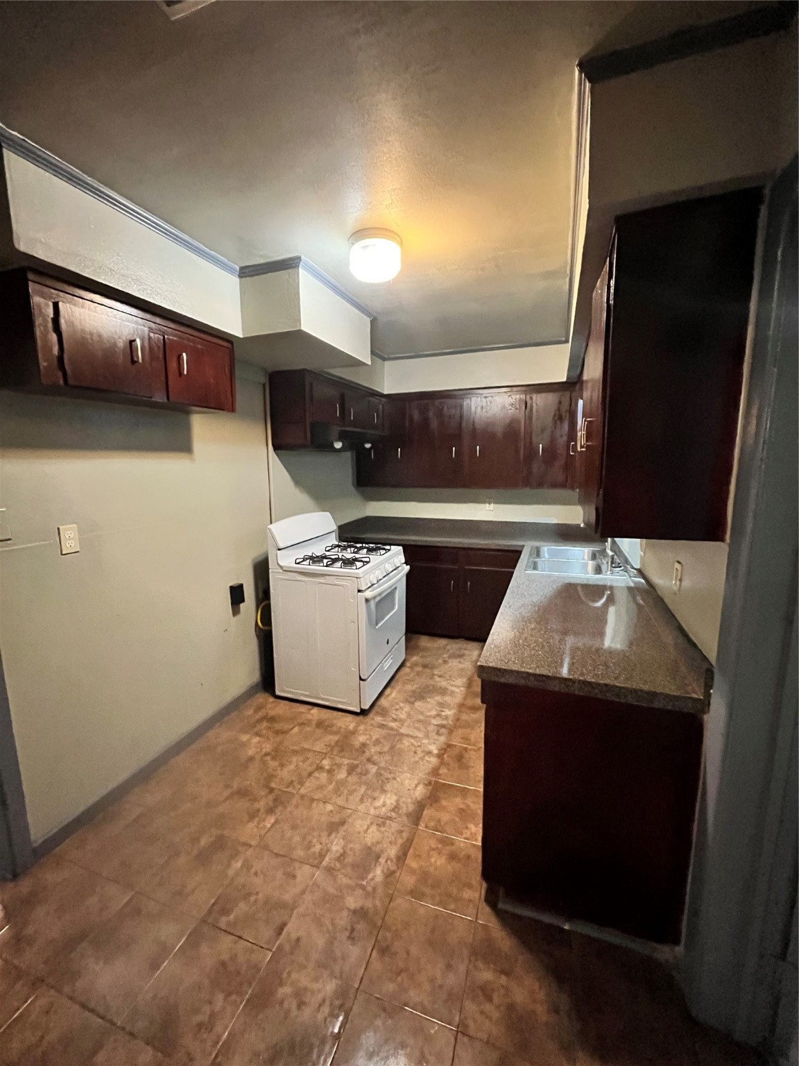 4609 Dabney Street Houston, TX 77026 - Photo 9 of 19 a kitchen with a sink and a stove top oven