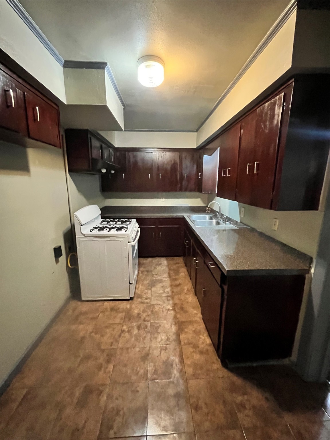 4609 Dabney Street Houston, TX 77026 - Photo 10 of 19 a kitchen with stainless steel appliances granite countertop a sink a stove and a refrigerator