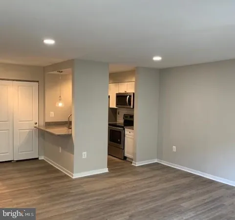 a view of a kitchen with a sink and a refrigerator