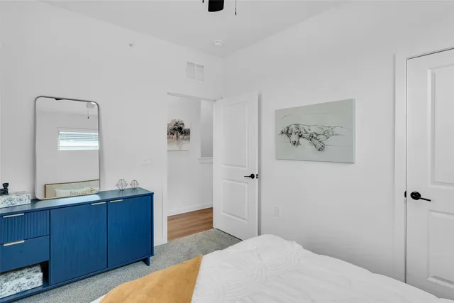 a bedroom with a bed and a mirror