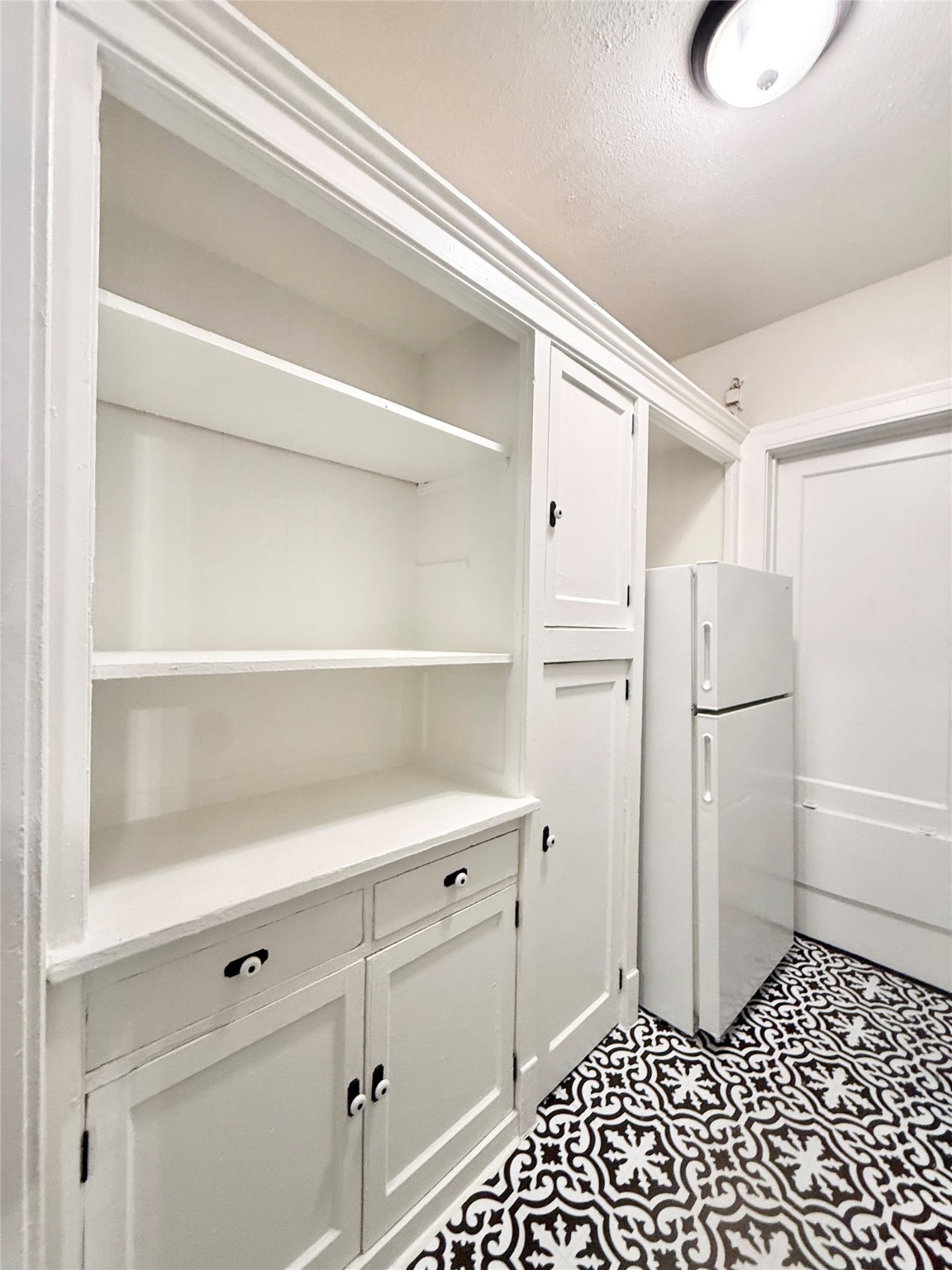 3920 Fannin Street, Unit 103 Houston, TX 77004 - Photo 12 of 24 a kitchen with a refrigerator and cabinets