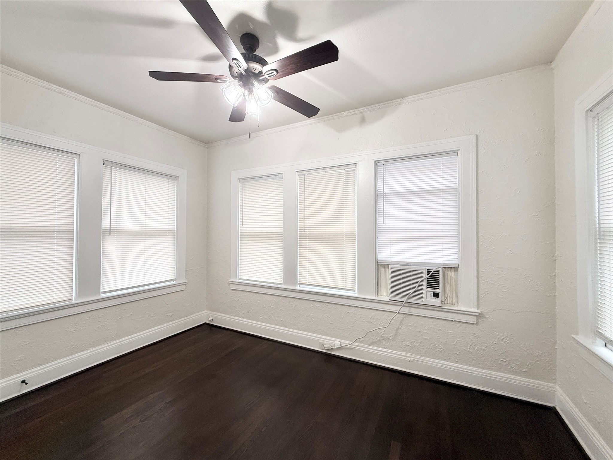 3920 Fannin Street, Unit 103 Houston, TX 77004 - Photo 14 of 24 an empty room with wooden floor fan and windows
