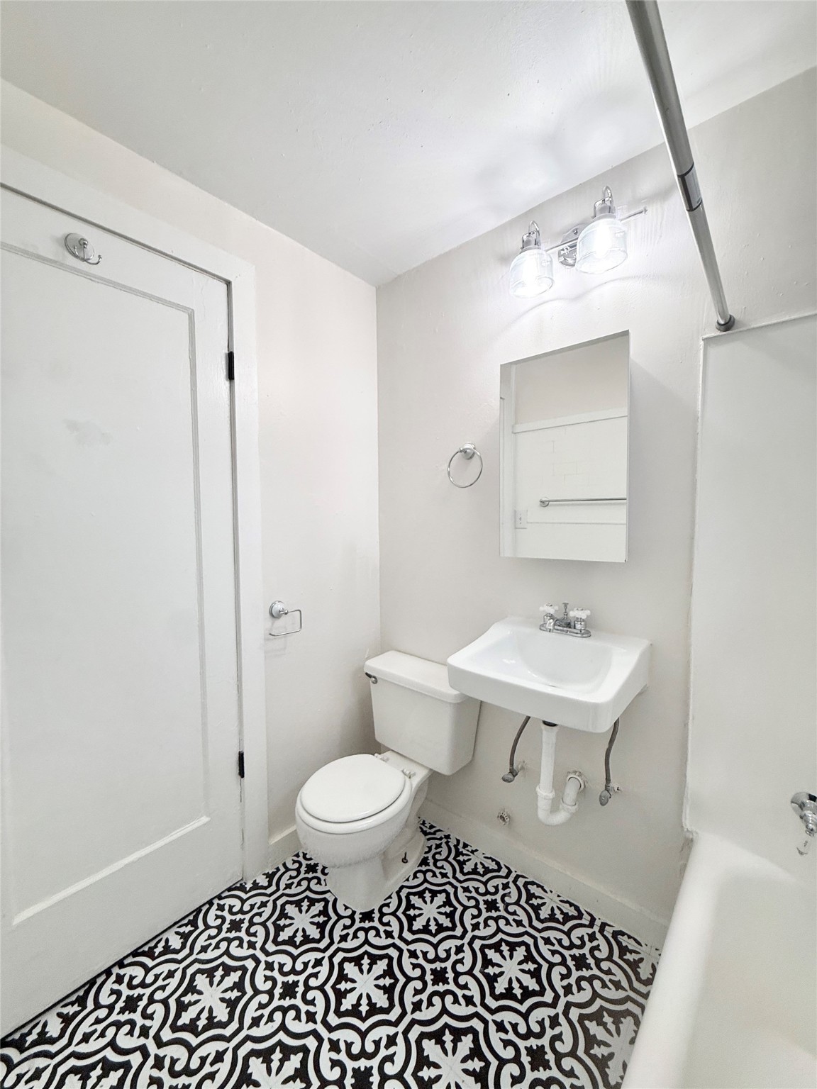 3920 Fannin Street, Unit 103 Houston, TX 77004 - Photo 21 of 24 a bathroom with a sink toilet a mirror and vanity