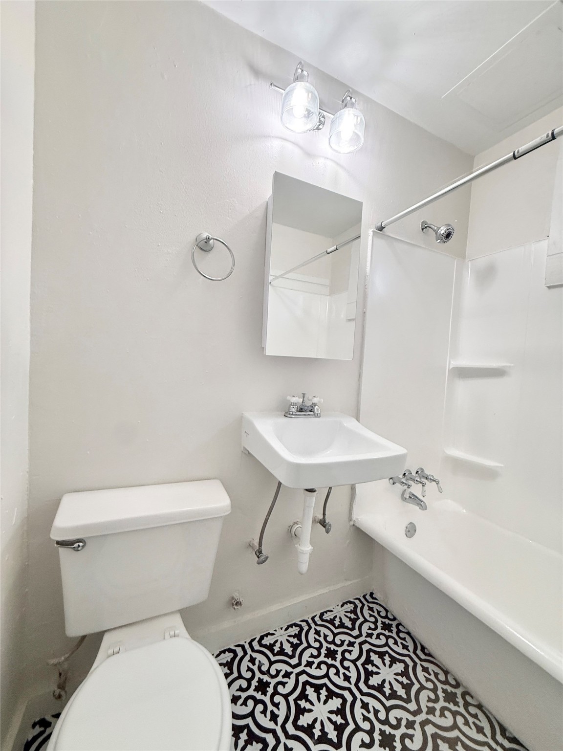 3920 Fannin Street, Unit 103 Houston, TX 77004 - Photo 23 of 24 a bathroom with a sink toilet a mirror and shower
