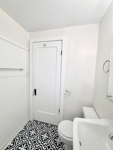 a bathroom with a toilet and a shower
