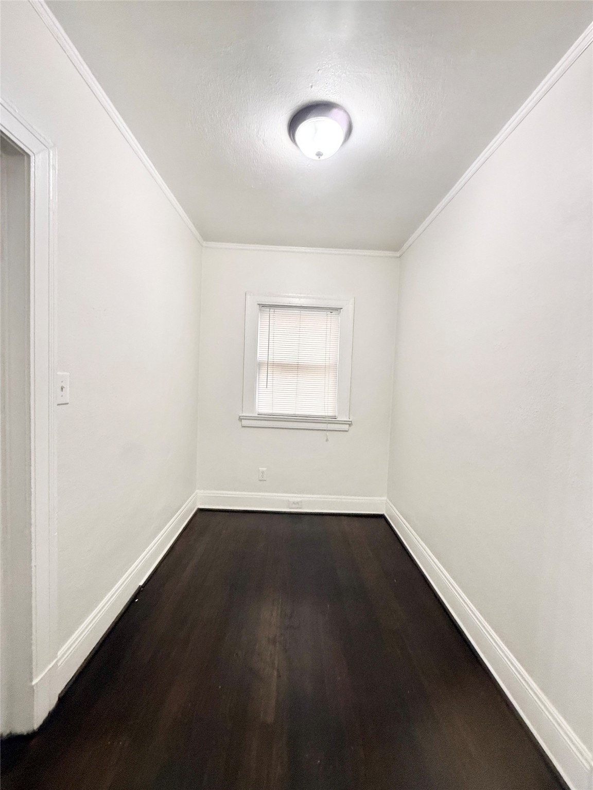 3920 Fannin Street, Unit 103 Houston, TX 77004 - Photo 8 of 24 an empty room with wooden floor and windows