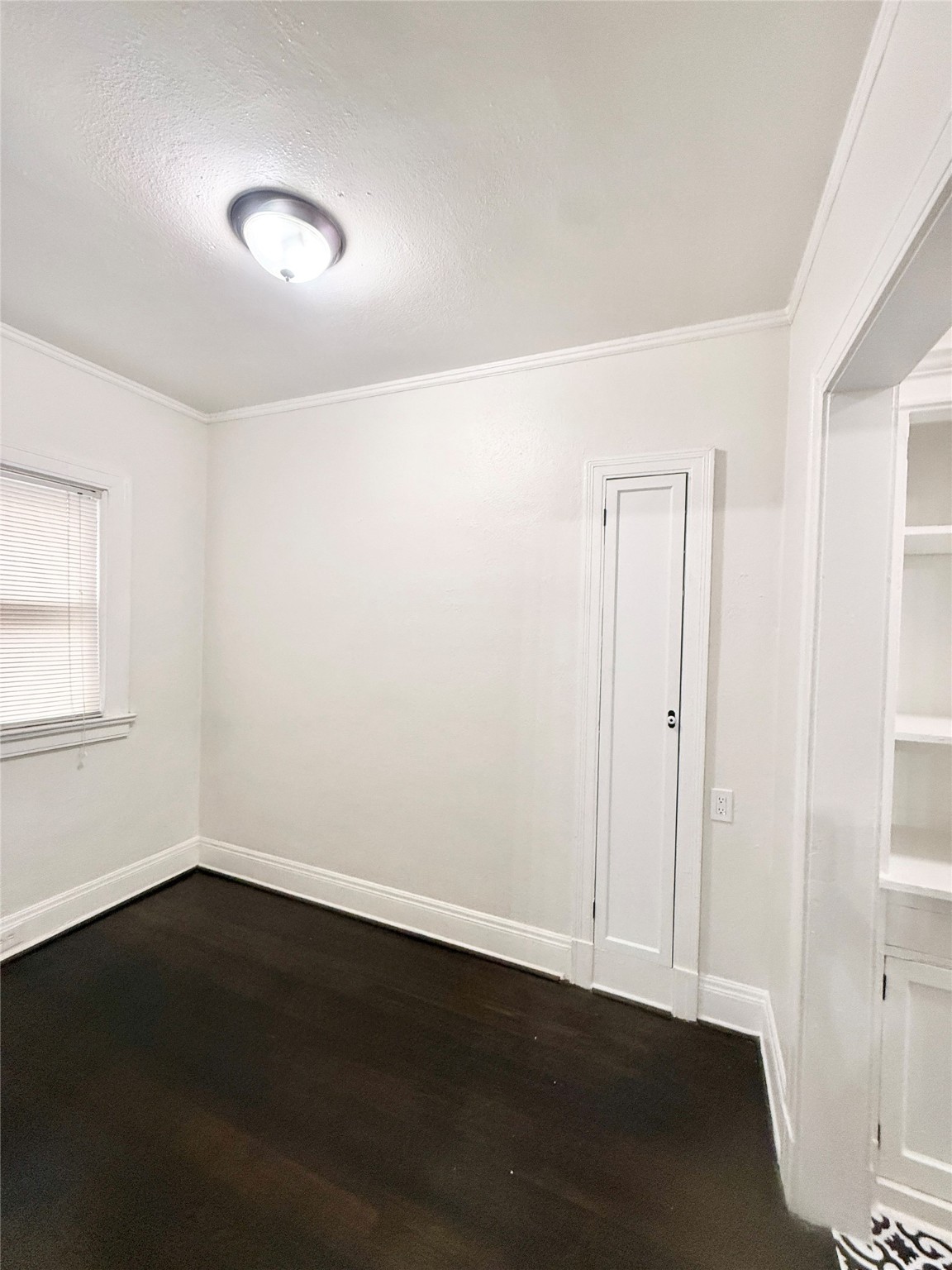 3920 Fannin Street, Unit 103 Houston, TX 77004 - Photo 9 of 24 a view of an empty room with wooden floor and a window