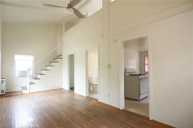 a view of a hallway with wooden floor and entryway