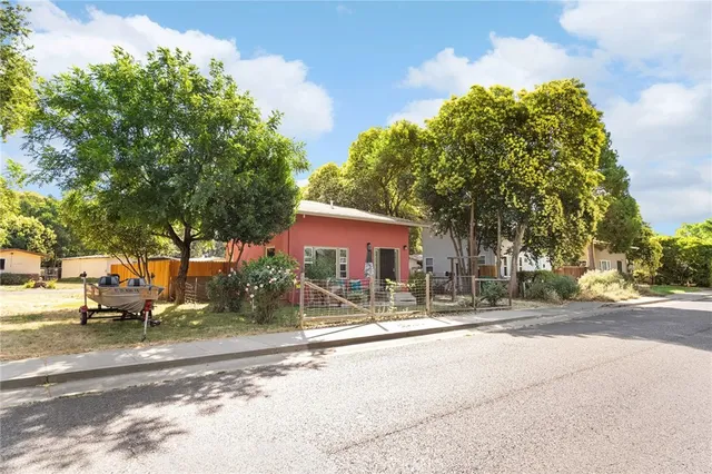a row of palm trees in front of a house