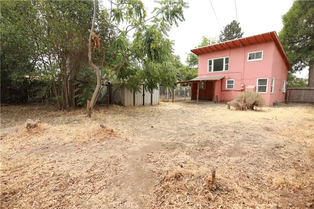 a view of a house with a yard covered in snow