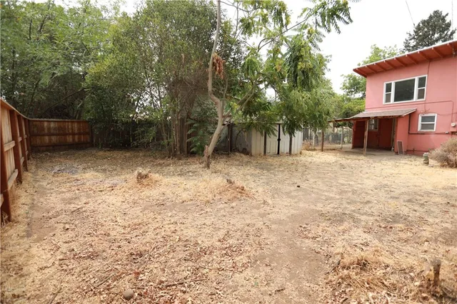 a backyard of a house with table and chairs