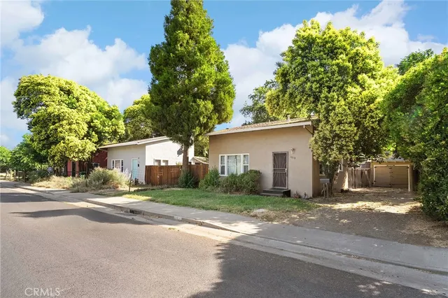 a front view of a house with a yard and a garage
