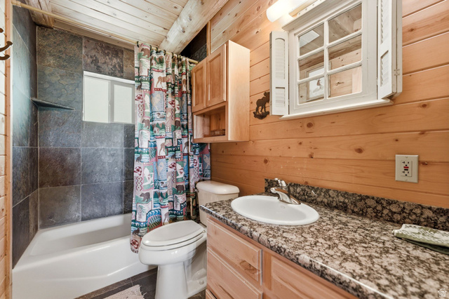 2096 South Aspen Ridge Coalville, UT 84017 - Photo 19 of 44 Bathroom featuring a tub/shower combination with dark tile surround, a built-in shelf, and a window