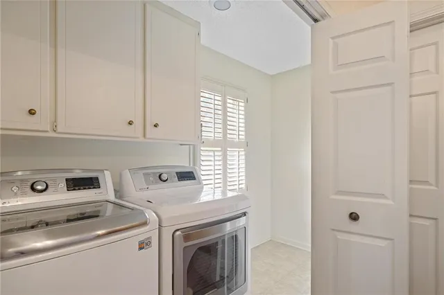 a view of washer and dryer with kitchen in the background