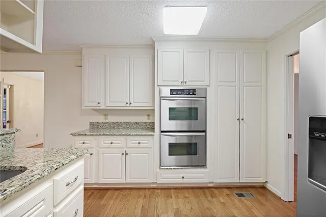 a kitchen with stainless steel appliances granite countertop a stove and a microwave