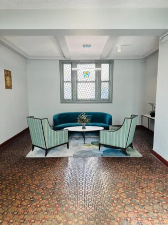 a living room with furniture a rug and a window