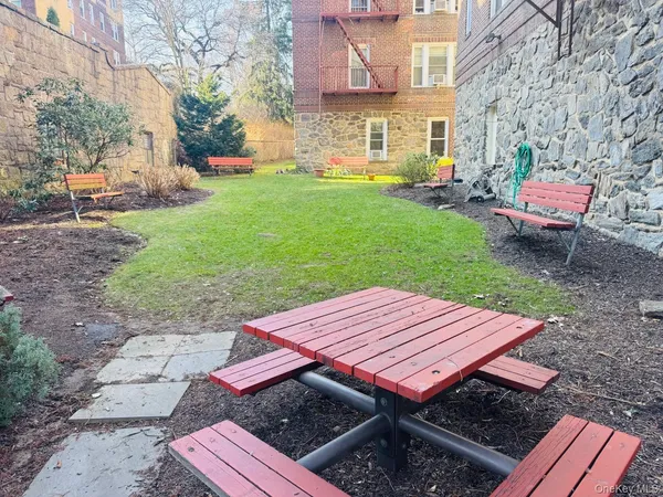 a wooden bench sitting in the backyard of a house
