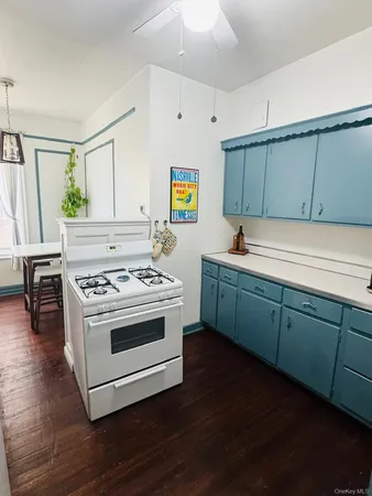 a kitchen with sink a stove and cabinets