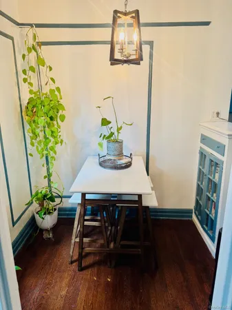 a view of a room with a table and a potted plant
